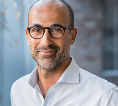 Man Wearing Glasses and Smiling