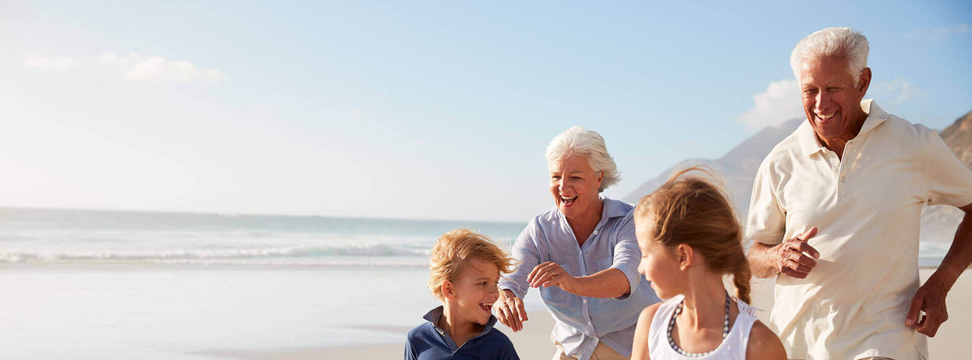 Grandparents Playing With Grandkids on the Beach